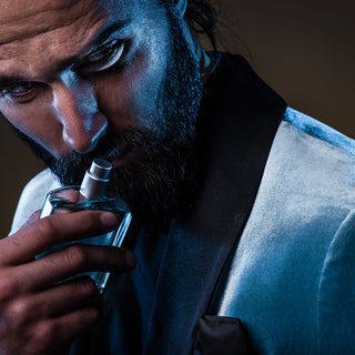 Sophisticated man smelling perfume